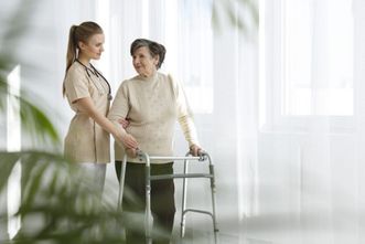 Nursing Aid Helping Patient